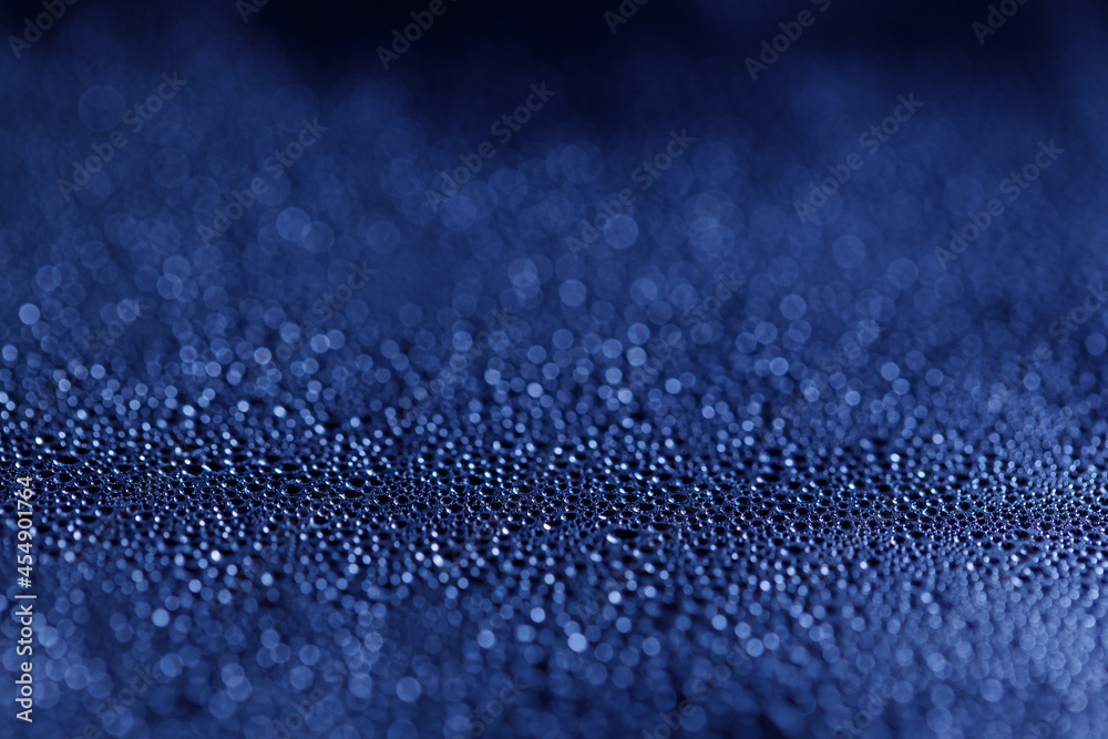 Drops on glass. Texture for designer background. Drops of water flow down the surface of the clear glass on a black background. Raindrops for overlaying on window. Concept of autumn weather.