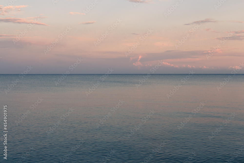 Fototapeta premium Marine Landscape. Clouds at sunset light over the sea.
