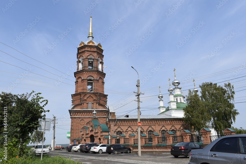 a tower with bells and a church with domes
