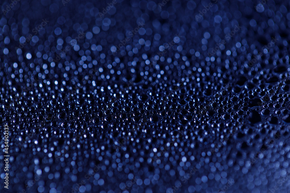 Drops on glass. Texture for designer background. Drops of water flow down the surface of the clear glass on a black background. Raindrops for overlaying on window. Concept of autumn weather. Drops on glass. Texture for designer background. Drops of water flow down the surface of the clear glass on a black background. Raindrops for overlaying on window. Concept of autumn weather.