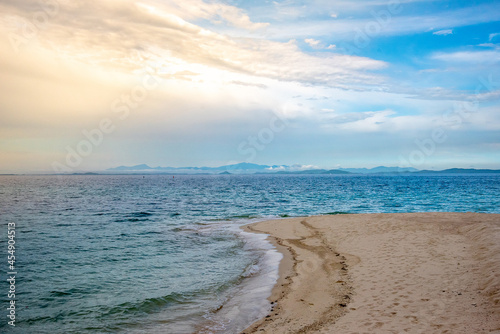 Nature in twilight period which including of sunrise over the sea and the nice beach. Summer beach with blue water and purple sky at the sunset.  