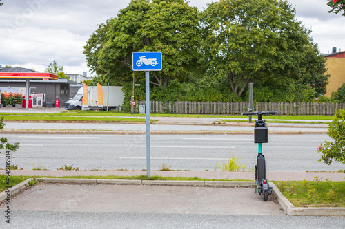 Fototapeta Naklejka Na Ścianę i Meble -  Beautiful view of electric scooter parked on parking lot for motorcycle. Sweden.