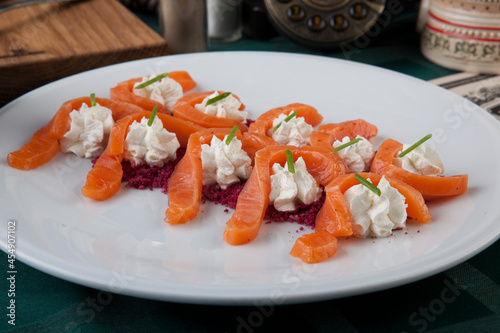salmon slices with cream cheese and beetroot sprinkles