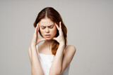 woman in white t-shirt depression symptoms headache light background