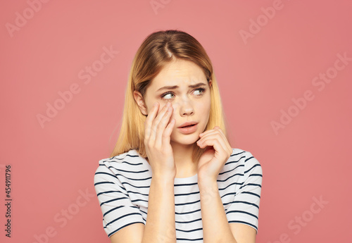 pretty woman in a striped T-shirt fun hand gestures isolated background
