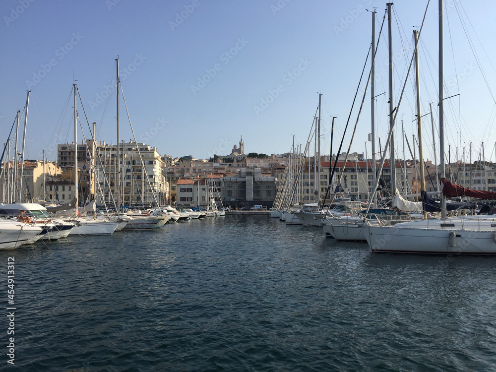 View of Notre-Dame de la Garde, a Catholic basilica in Marseille, France, seen from the sea in the  Old Port (Vieux Port) of Marseille.