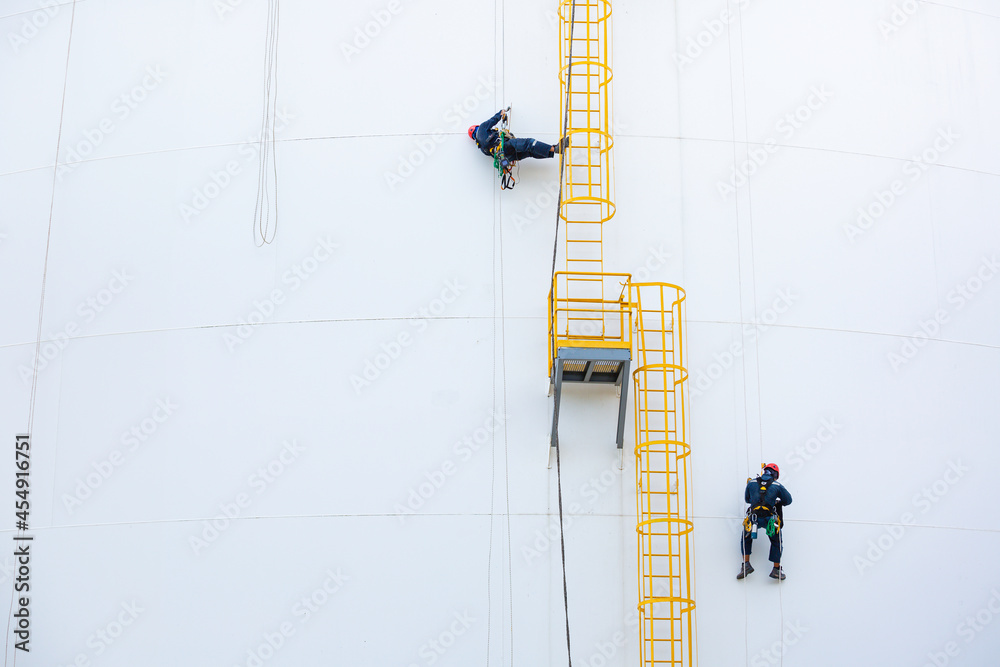Male two workers down height ladder tank rope access inspection of ...