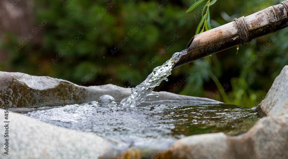 Mountain spring. A bowl with natural, cold drinking water. Ecology of the planet. Close-up. Japanese style. Mountain spring. A bowl with natural, cold drinking water. Ecology of the planet. Close-up. Japanese style.