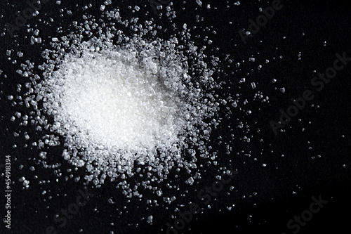 pile of white sugar on black background