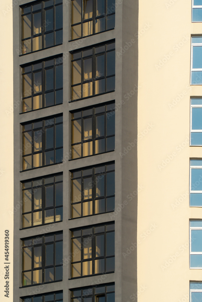 windows of a new brown multi-storey building in sunny summer weather windows of a new brown multi-storey building in sunny summer weather