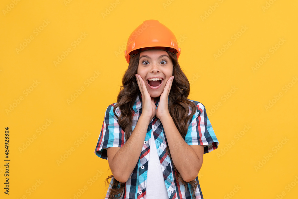 amazed kid with curly hair in construction helmet, engineer amazed kid with curly hair in construction helmet, engineer