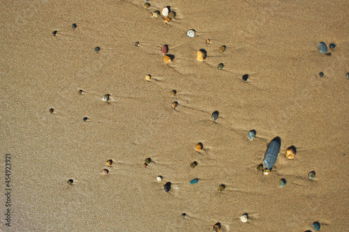 close up of a wet sand with pebbles