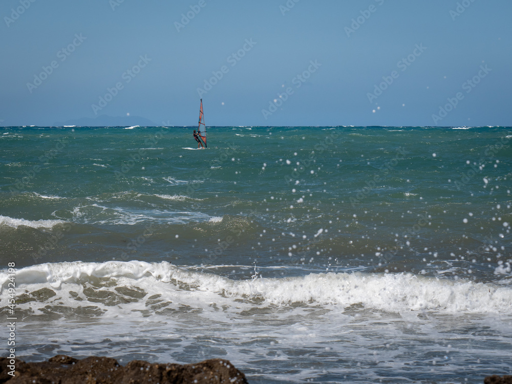 Windsurf Riding the Waves in a Choppy Sea