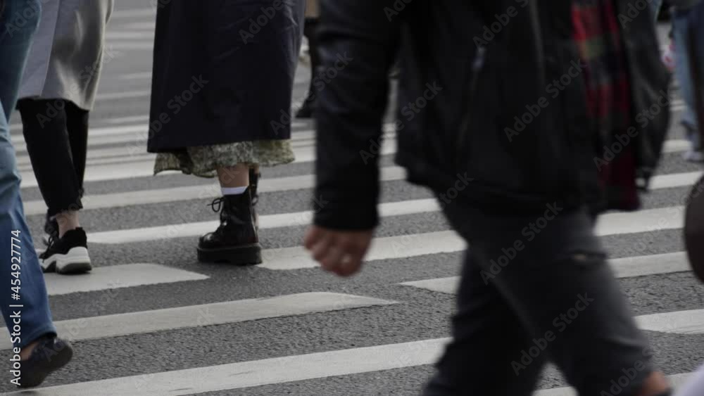 Pedestrian's legs going in crowd on the crosswalk Pedestrian's legs going in crowd on the crosswalk
