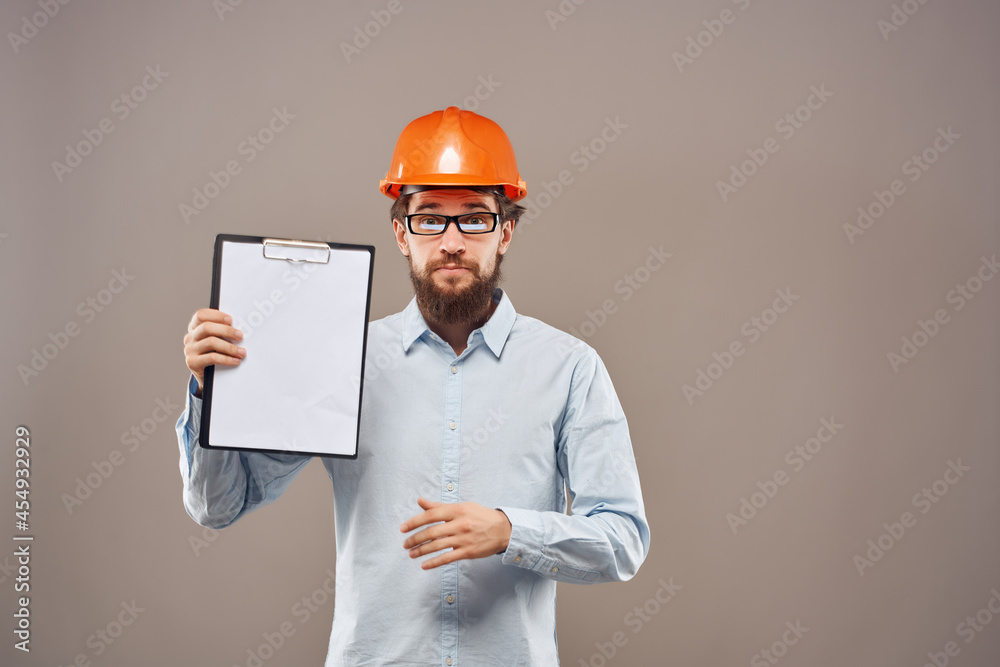 bearded man in orange hard hat engineer documents work bearded man in orange hard hat engineer documents work