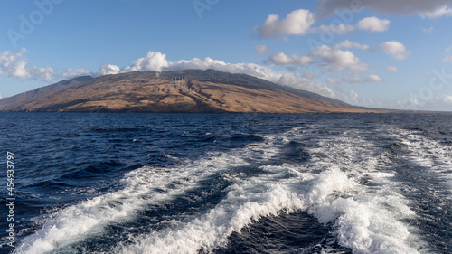 Sailing a catamaran across Maalaea Bay and looking back towards Wailuku and the island of Maui, Hawaii.  photo