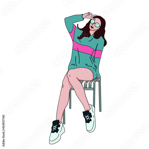 A brunette girl in a blue sweater and sneakers shows a victory sign