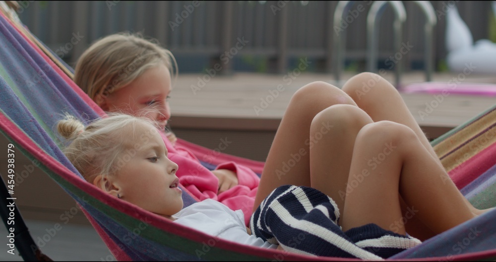 two sisters having rest in hammock