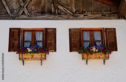 beautiful old rutic house with flowers on the windows in Mittenwald in Bavaria (Germany) photo