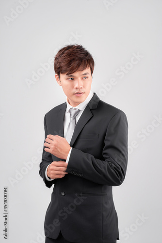 Portrait of handsome Asian businessman looking away
