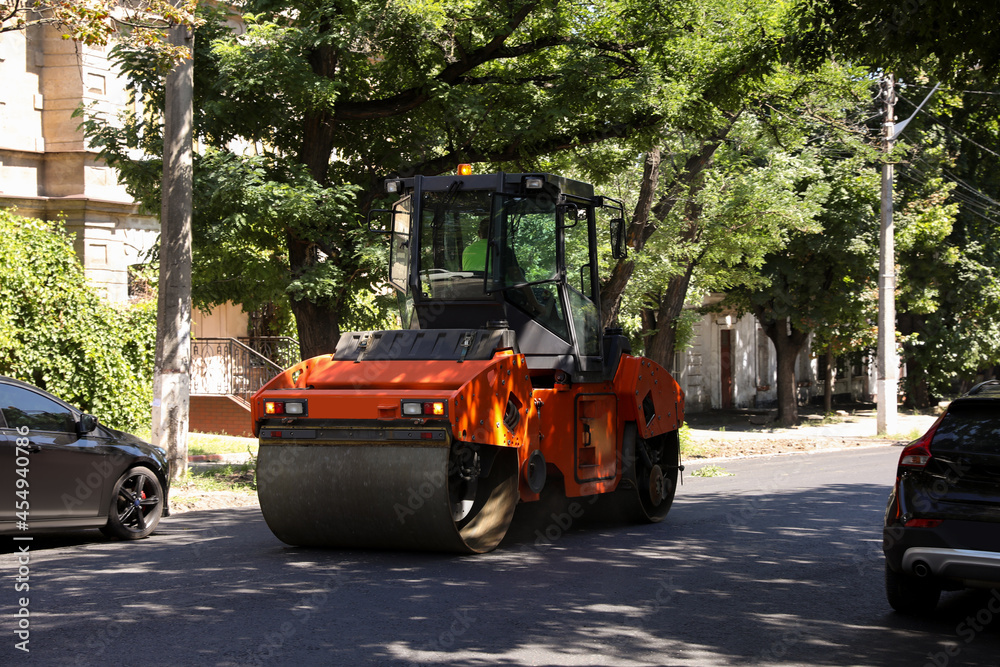 Modern roller on city street. Road repair service Modern roller on city street. Road repair service