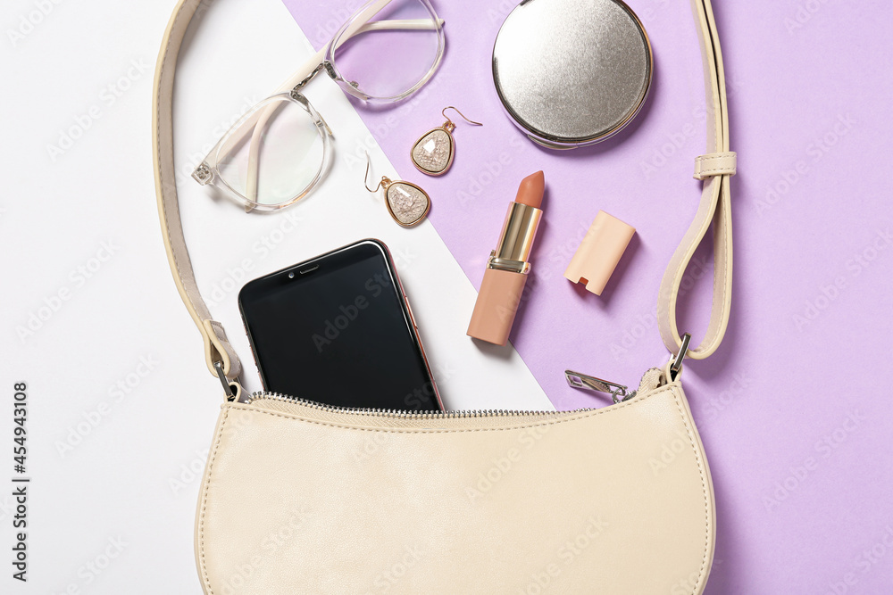 Stylish women's bag and different stuff on color background, flat lay Stylish women's bag and different stuff on color background, flat lay