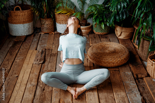 Strong fortitude, exercises for health. A female instructor is engaged in yoga in the asana pose. Aerobics is a warm-up of joints and muscles. Balance is the harmony of the soul and body.