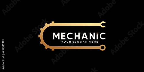 Creative mechanic logo design with gear and wrench in golden gradient style color Premium Vector