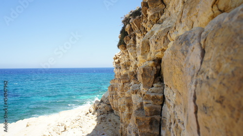 beach and rocks cliff in the Greek island of koufonisi August 2021