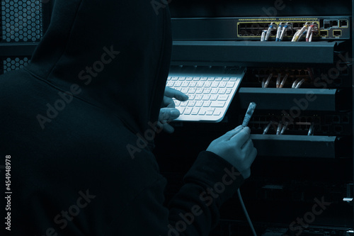 Cyber crime concept. Hacker working on a code on dark digital background with digital interface system