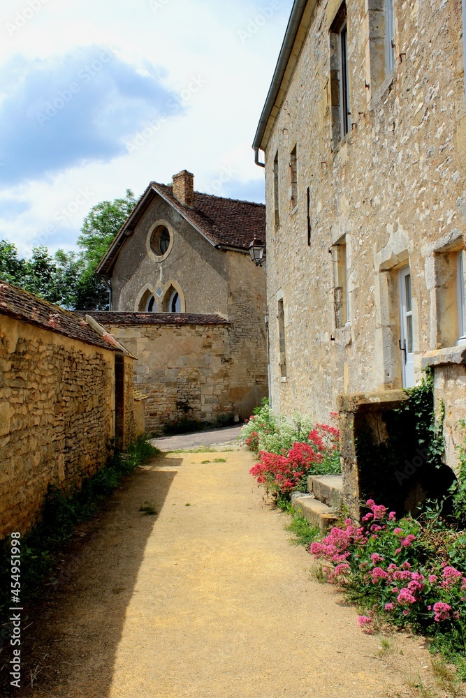Beautiful European village of Vezelay in France, Burgundy. A narrow ancient French street of a medieval town with old buildings and houses and stone walls, a popular travel destination.