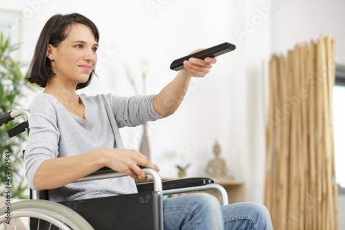 Wall Mural beautiful brunette changing tv station in the living room