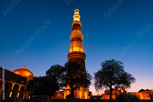 Silhouette of Qutub Minar a highest minaret in India standing 73 m tall tapering tower of five storeys made of red sandstone. It is UNESCO world heritage site at  New Delhi,India photo