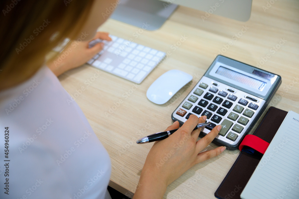 Business woman using calculator for her financial analysis. Business woman using calculator for her financial analysis.