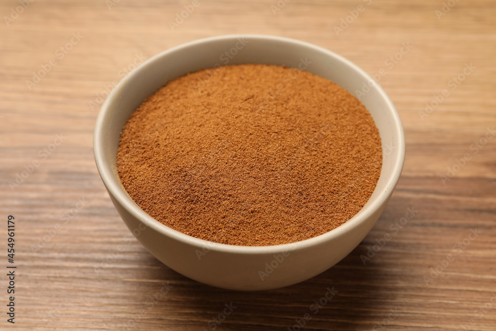 Bowl of chicory powder on wooden table Bowl of chicory powder on wooden table
