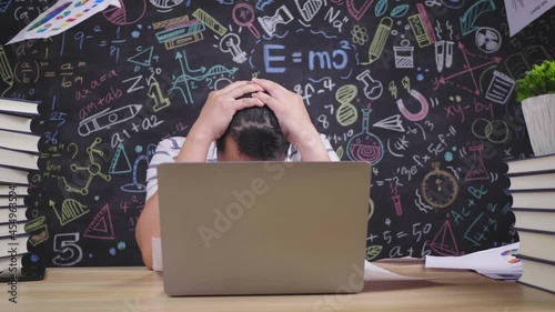 Close up of Tired asian teacher glasses man throwing paper while sitting at desk in classroom. Male teacher touching head and taking off glasses. Education concept.