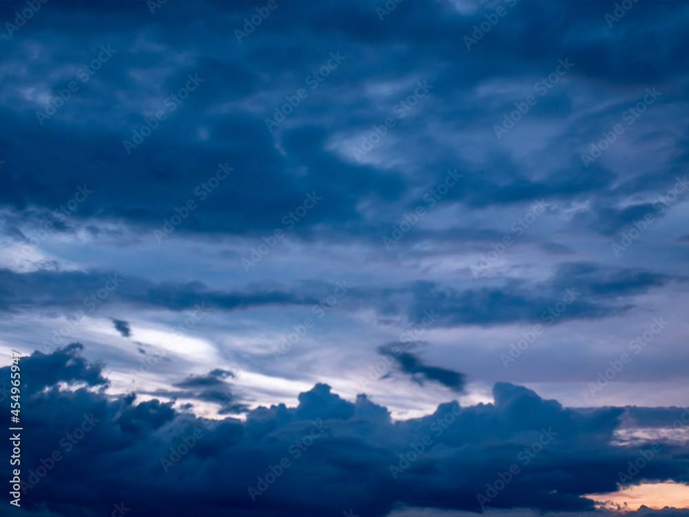 Naklejka premium A panorama of the evening sky with dark blue clouds of various shades.