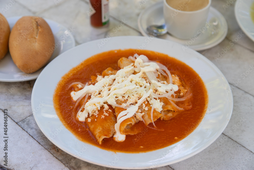Red Enchiladas - traditional mexican food with tomato sauce and cheese in Mexico Red Enchiladas - traditional mexican food with tomato sauce and cheese in Mexico