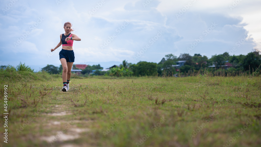 Woman using smart watch during training outdoors. Woman using smart watch during training outdoors.