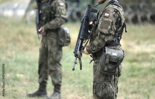 Fotografia, Obraz Soldiers of Poland with assault rifle and flag of Poland on military uniform
