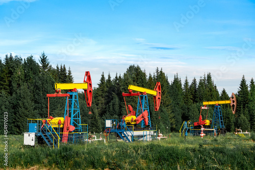 oil pumping stations in a clearing in the forest