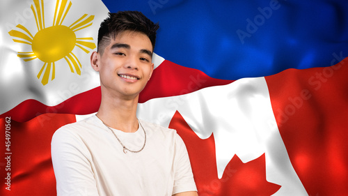 A proud young Filipino-Canadian, from 18-24, with both Philippine and US flags as background. Naturalized immigrant or 2nd generation birthright citizenship. photo