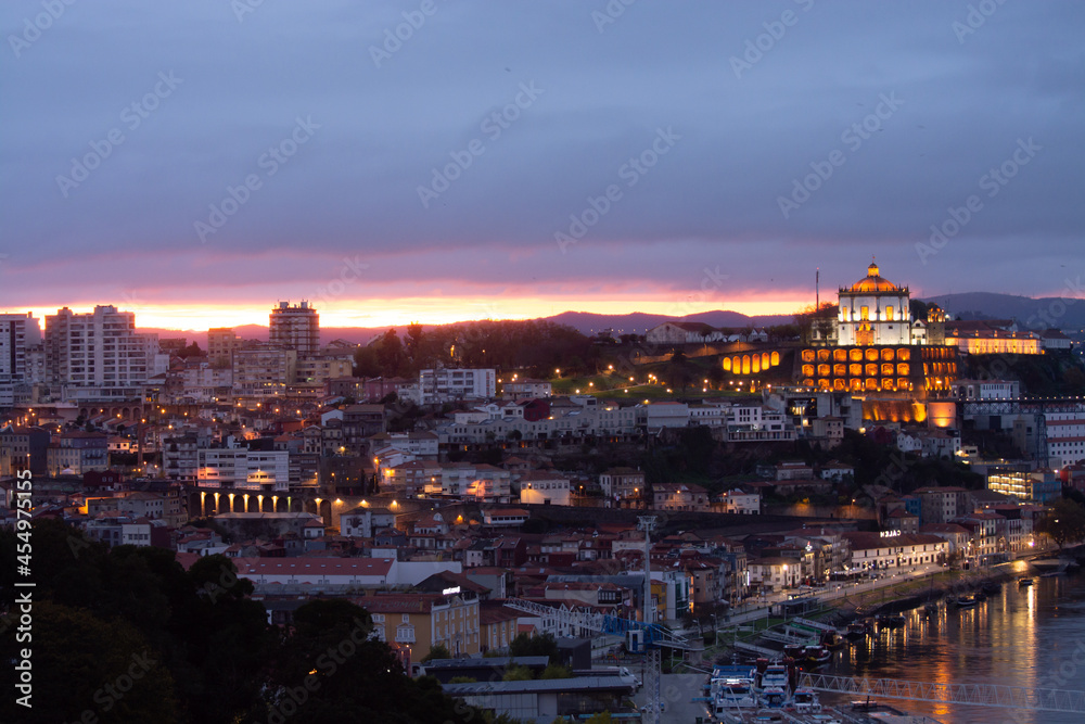 Panoramic view on Douro river and old part of Porto city in Portugal at cloudy sunset