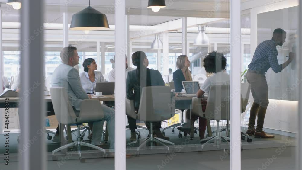 group of business people meeting in boardroom team leader man presenting ideas on whiteboard discussing strategy with colleagues in office training presentation 4k