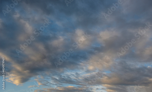 Russia. The South of Eastern Siberia. Gloomy sunset clouds in the evening summer sky over the mountain ranges of Eastern Sayan.