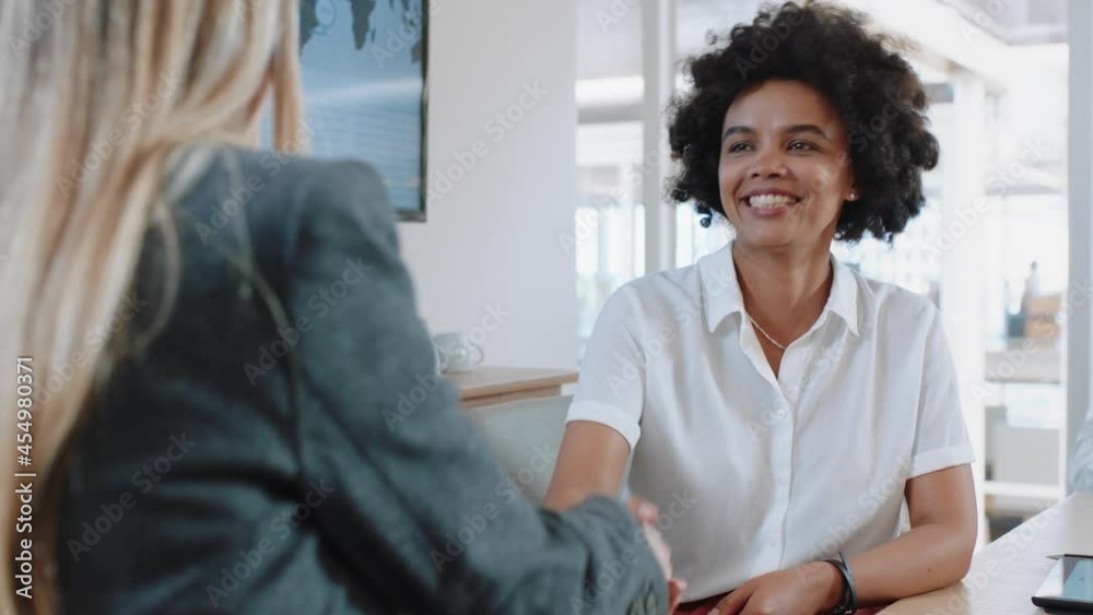 successful job interview happy mixed race business woman intern shaking hands with manager in meeting congratulations for new career opportunity in corporate office successful job interview happy mixed race business woman intern shaking hands with manager in meeting congratulations for new career opportunity in corporate office