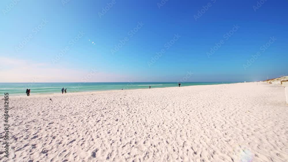 Gulf of mexico emerald coast sea ocean water on sunny winter day Seaside, Florida beach on panhandle with people sunbathing along white quartz sand Gulf of mexico emerald coast sea ocean water on sunny winter day Seaside, Florida beach on panhandle with people sunbathing along white quartz sand