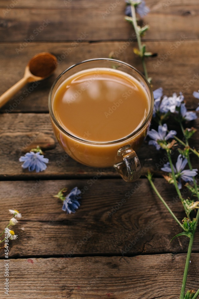 Glass mug with chicory drink on wooden background Glass mug with chicory drink on wooden background