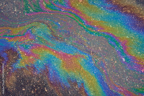 Abstract background from motor oil, gas or petrol spilled on asphalt