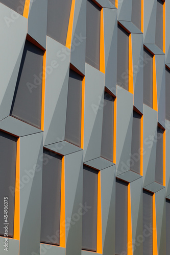 Modern Facade Detail. Grey and Orange Cladding.